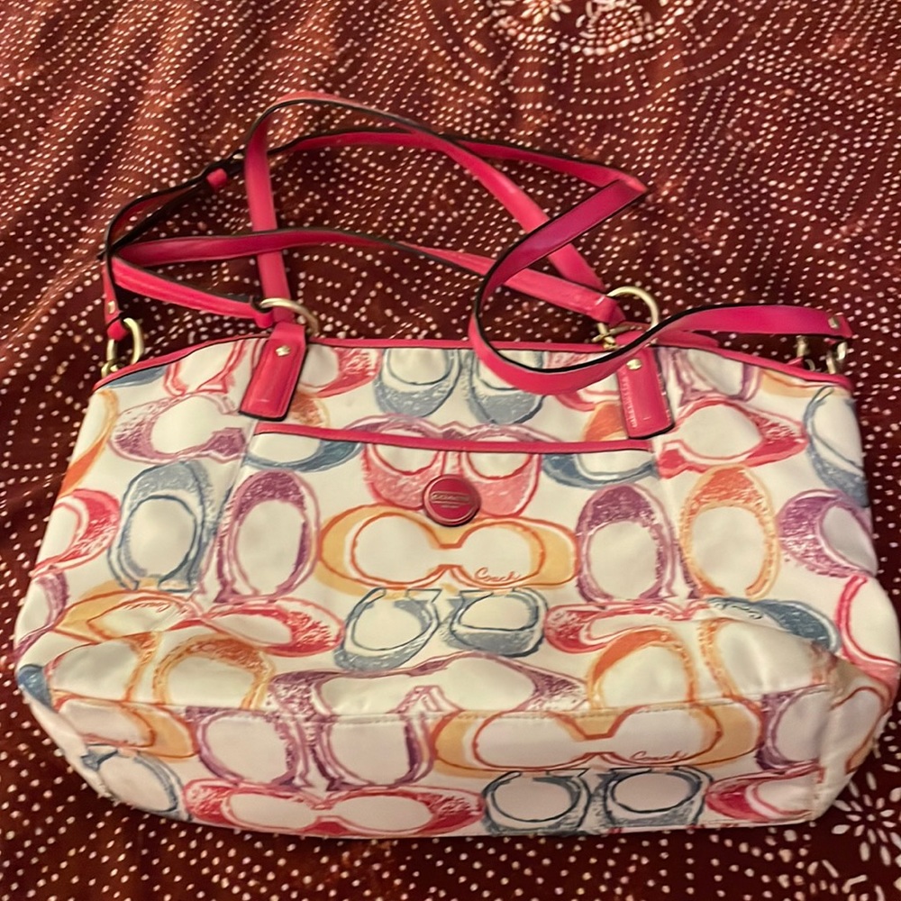Coach Scribble tote with poppy red/pink handles.